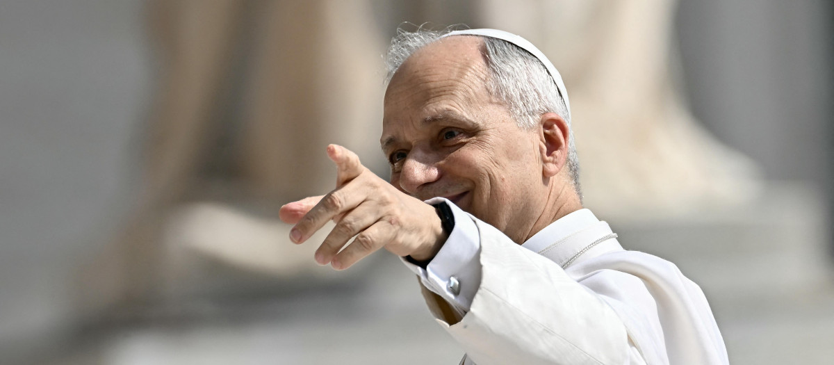 Pope Leo XIV waves to the crowd as he arrives to hold the weekly general audience in St Peter's Square at the Vatican, on June 11, 2025. (Photo by Filippo MONTEFORTE / AFP)
