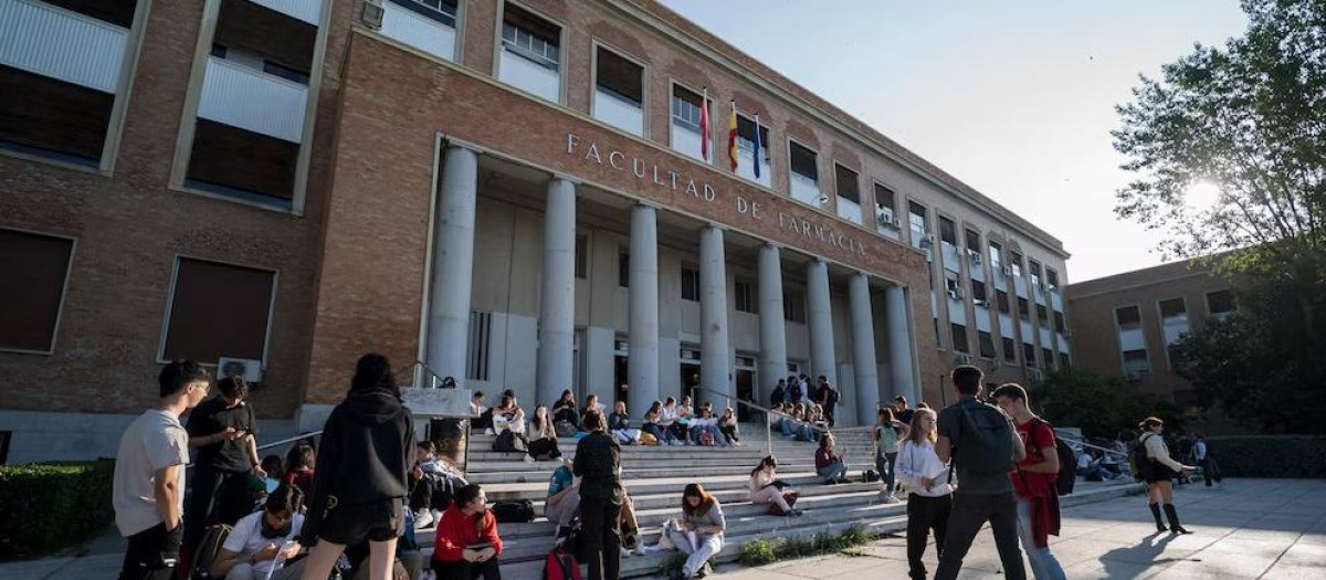 Un grupo de estudiantes frente a las puertas de la Facultad de Farmacia de la Universidad Complutense de Madrid.