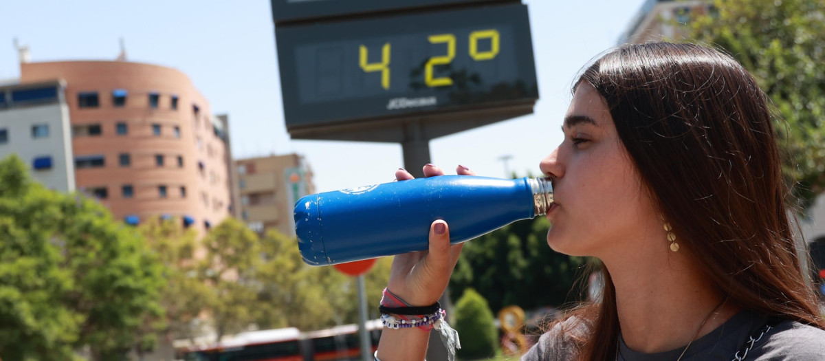 Una joven bebe agua para soportar las altas temperaturas