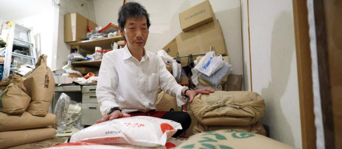 A store owner organizes the rice in the warehouse in Osaka City, Osaka Prefecture, Japan, on June 25, 2025. Rising rice prices have become a social issue like the "rice riot" in Japan. On the 23rd, the Ministry of Agriculture, Forestry and Fisheries announced that the average price of rice per 5 kilograms sold at supermarkets nationwide (from the 9th to the 15th) was 3,920 yen (28.69 dollar), 256 yen lower than the previous week. The government and ruling party are focusing on rice price measures, and the success or failure of the price reduction is expected to be directly linked to the outcome of the House of Councillors election this summer. ( The Yomiuri Shimbun ) (Photo by Nanako Sudo / The Yomiuri Shimbun via AFP)