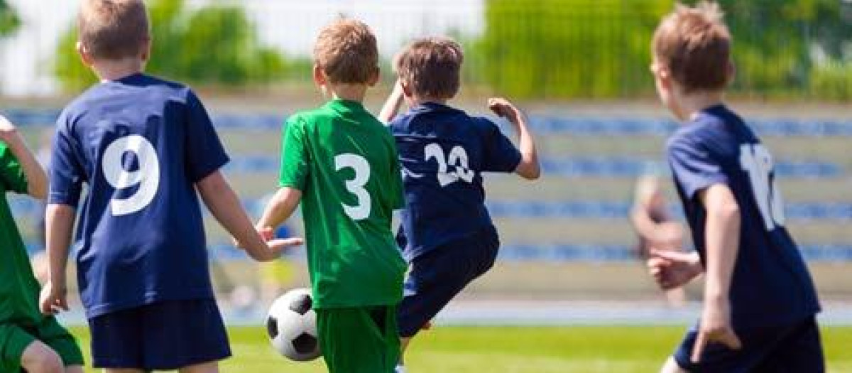 Football Match For Children. Training and Football Soccer School Tournament. Group of Boys Playing Football