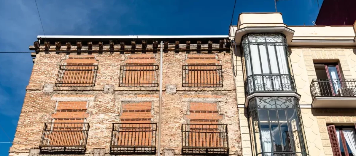 Antiguo edificio residencial con ventanas tapiadas para evitar la entrada de okupas