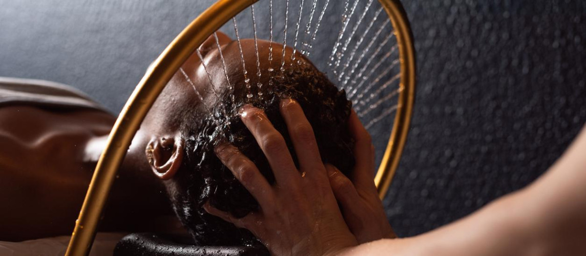 Close up of relaxing hair wash at a salon.