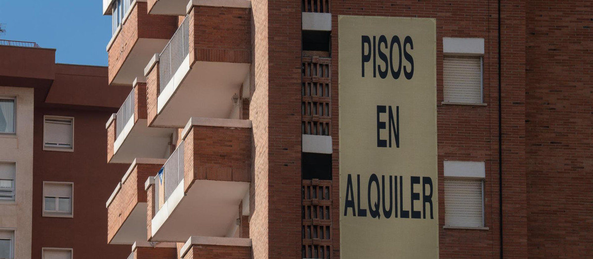 Cartel de alquiler de viviendas en la fachada de un edificio