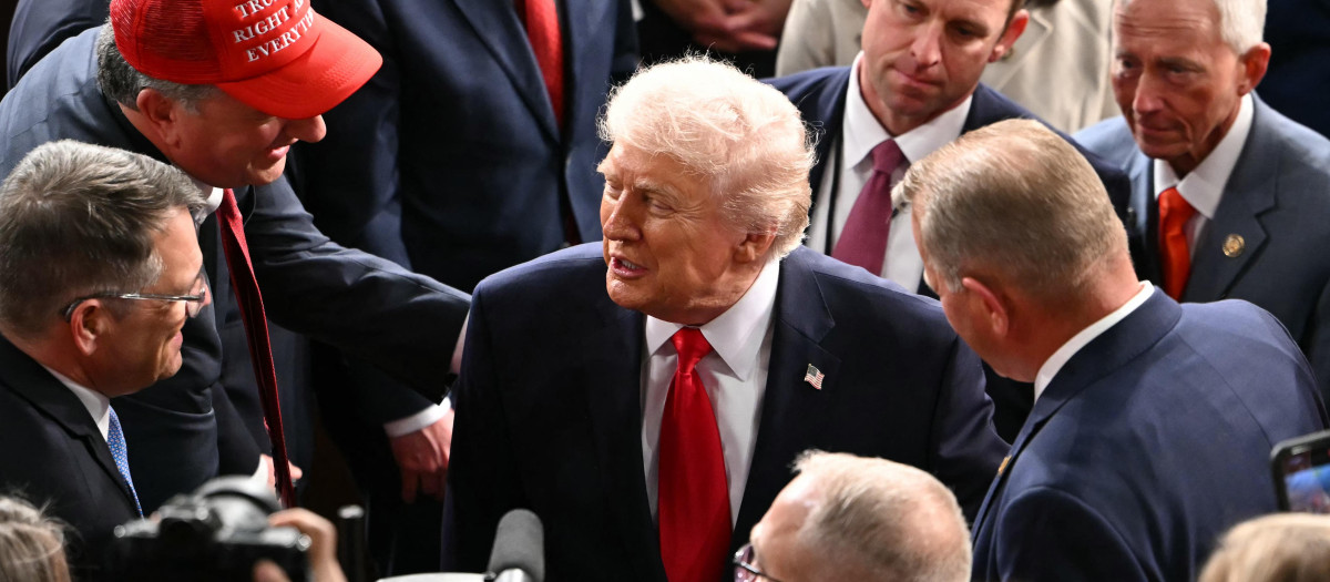 US President Donald Trump shakes hands with members of Congress as he departs following his State of the Union address in the House Chamber of the US Capitol in Washington, DC, on February 24, 2026. (Photo by ANDREW CABALLERO-REYNOLDS / AFP)