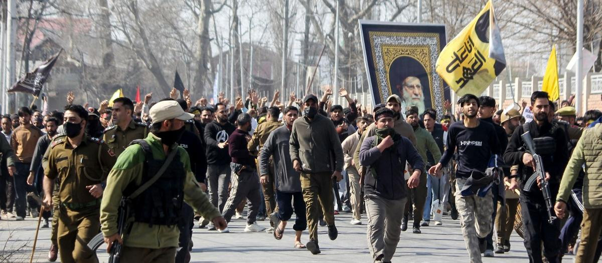Shia Muslim demonstrators hold a portrait of Iran's late supreme leader Ayatollah Ali Khamenei in Srinagar on March 2, 2026 after restrictions were imposed amid protests over his death by US-Israel strikes. (Photo by Habib NAQASH / AFP)