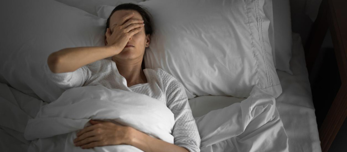Woman feeling sick and tired in the bed.
