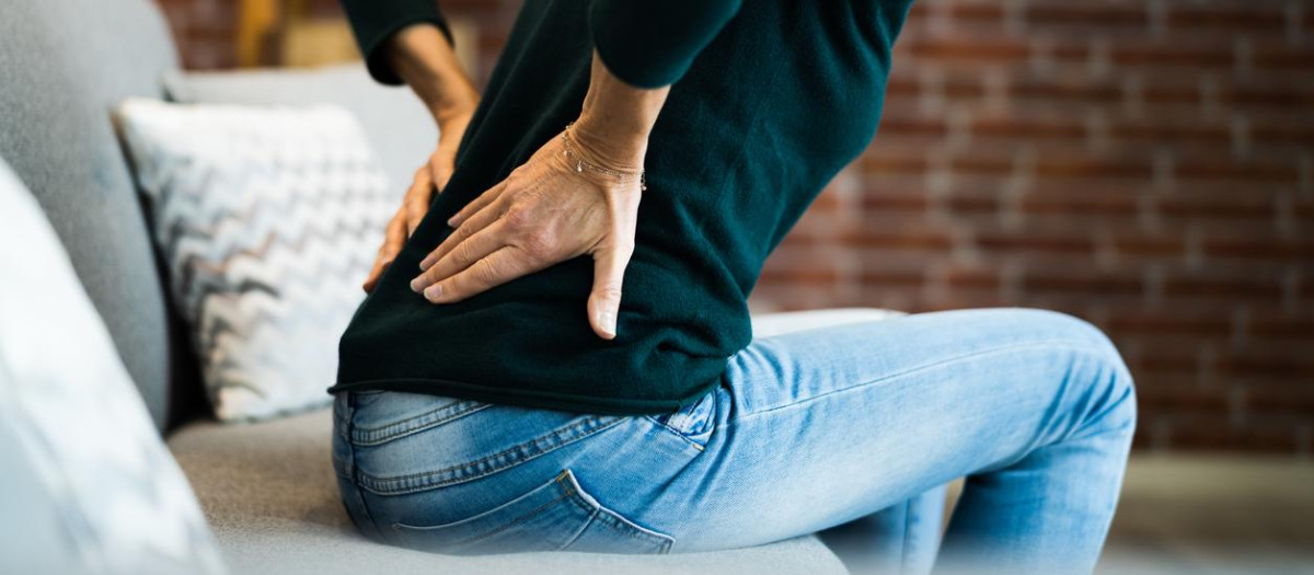 Woman With Back Pain And Ache. Bad Posture