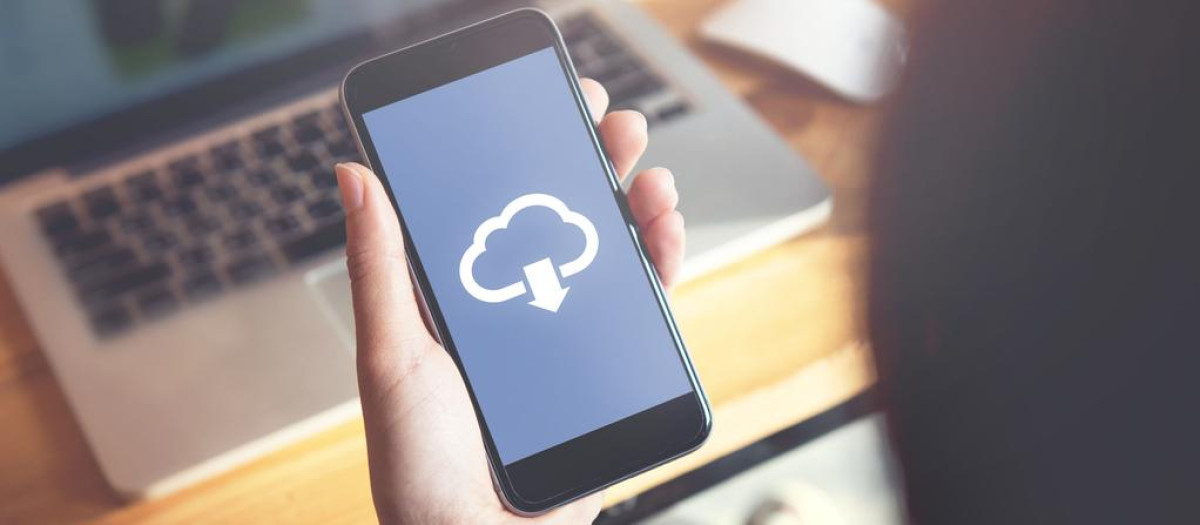 Closeup hand of woman with Cloud download on mobile smartphone.