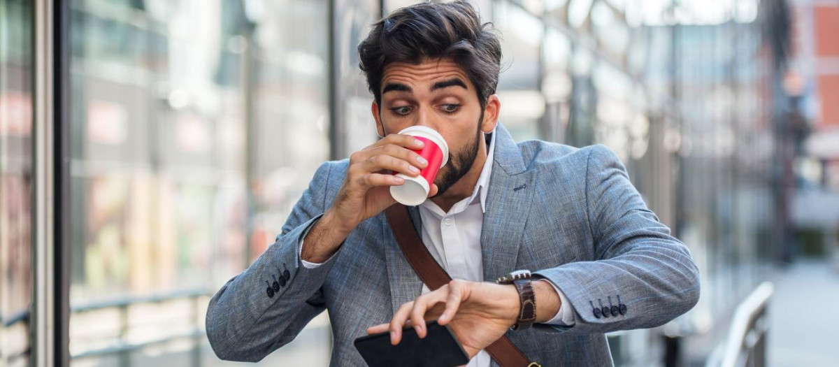 Never don't be late on business meeting. Worried businessman looking at his watch on the way to office. Business, lifestyle concept