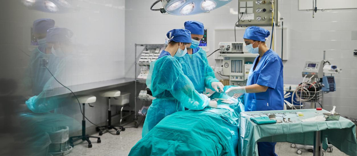 Team of surgeons in operating room at a hospital.