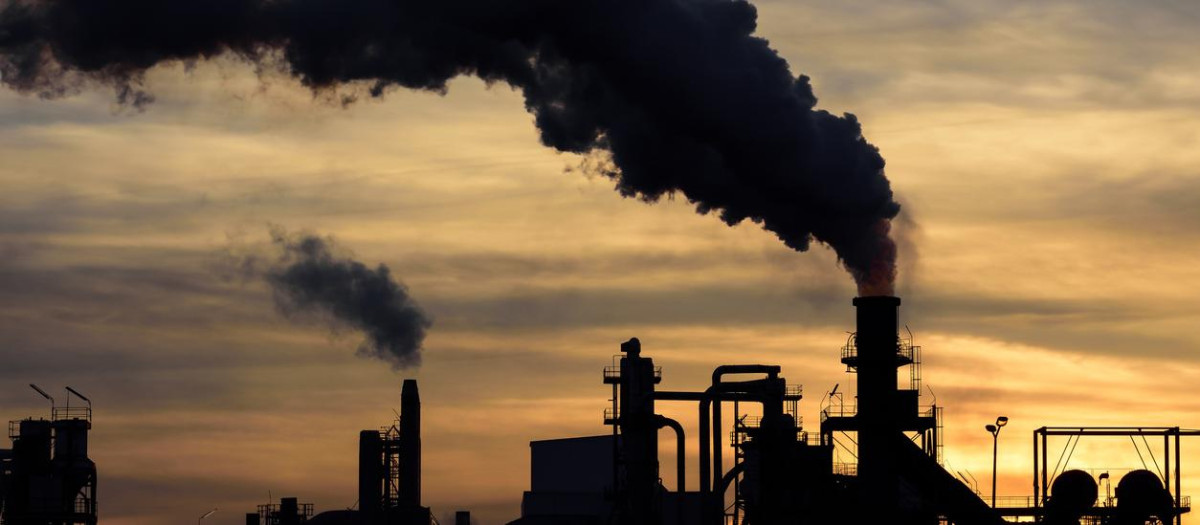 a cloud of pollution released by an industry.