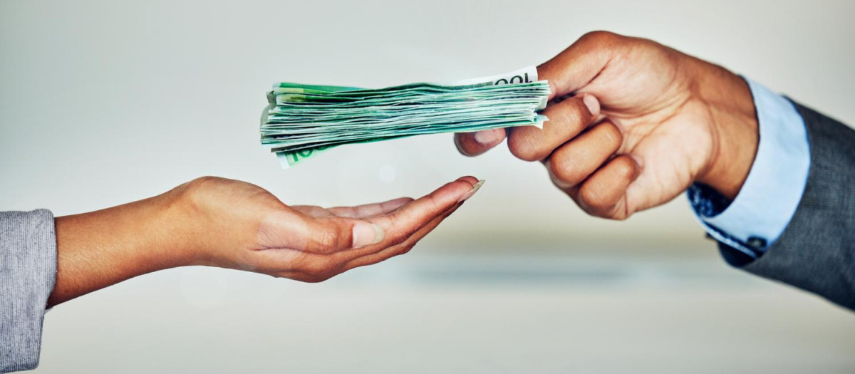 Paper money, payment or loan cash from a finance manager, banking employee or boss. Hand holding bank notes for financial investment profit, wealth growth for investing, retirement and budget