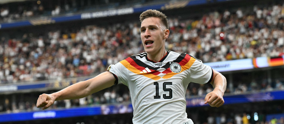 Germany's defender #15 Nico Schlotterbeck celebrates after scoring his team's second goal  during the 2026 World Cup Group E football match between Germany and Curacao at the Houston Stadium in Houston on June 14, 2026.  (Photo by RONALDO SCHEMIDT / AFP)