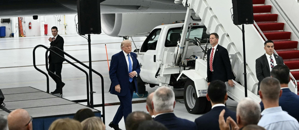 US President Donald Trump speaks in front of the new Air Force One, gifted to him by by Qatar, in a hangar at Joint Base Andrews in Maryland on June 19, 2026. White House officials bade farewell on June 18, 2026 to one of the two jets that have been used to transport US presidents for more than 30 years. The goodbye messages fueled speculation that a Boeing 747 controversially gifted to President Donald Trump by the Gulf emirate of Qatar is now due to enter service. Trump will be heading to Joint Base Andrews before spending the weekend at Camp David. (Photo by Brendan SMIALOWSKI / AFP)