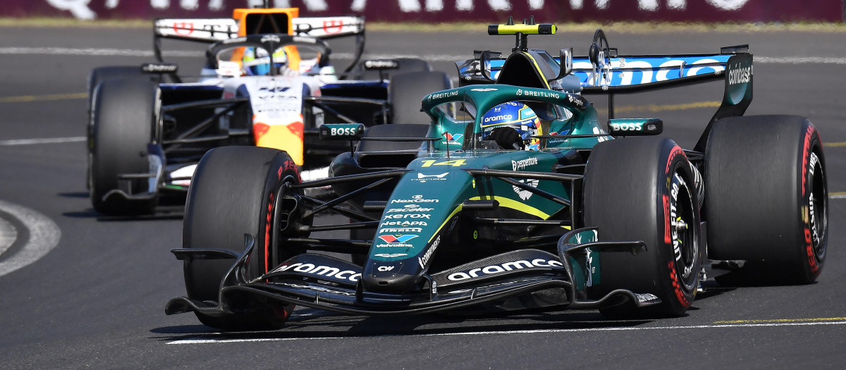 Aston Martin's Spanish driver Fernando Alonso competes ahead of Racing Bulls' British driver Arvid Lindblad during the Formula One Hungarian Grand Prix at the Hungaroring racetrack in Mogyorod near Budapest, Hungary, on July 26, 2026. (Photo by Ferenc ISZA / AFP)