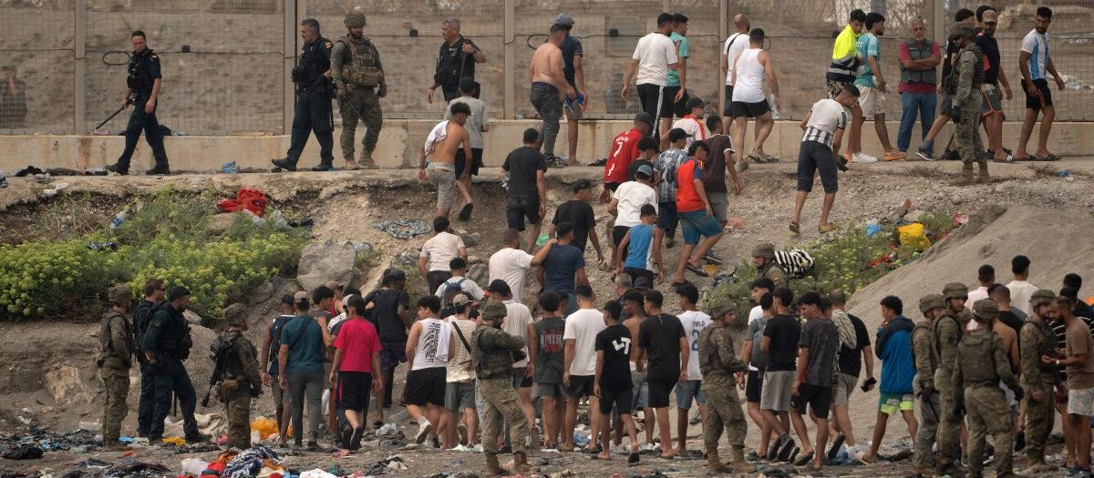 Soldados españoles supervisan el regreso de inmigrantes a Marruecos tras haber cruzado la frontera para entrar en el enclave español de Ceuta