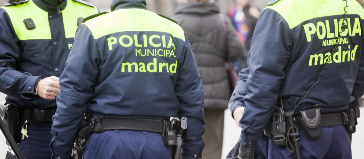 Muncipal Policemen  on duty in Madrid, armed with truncheons and pistols.