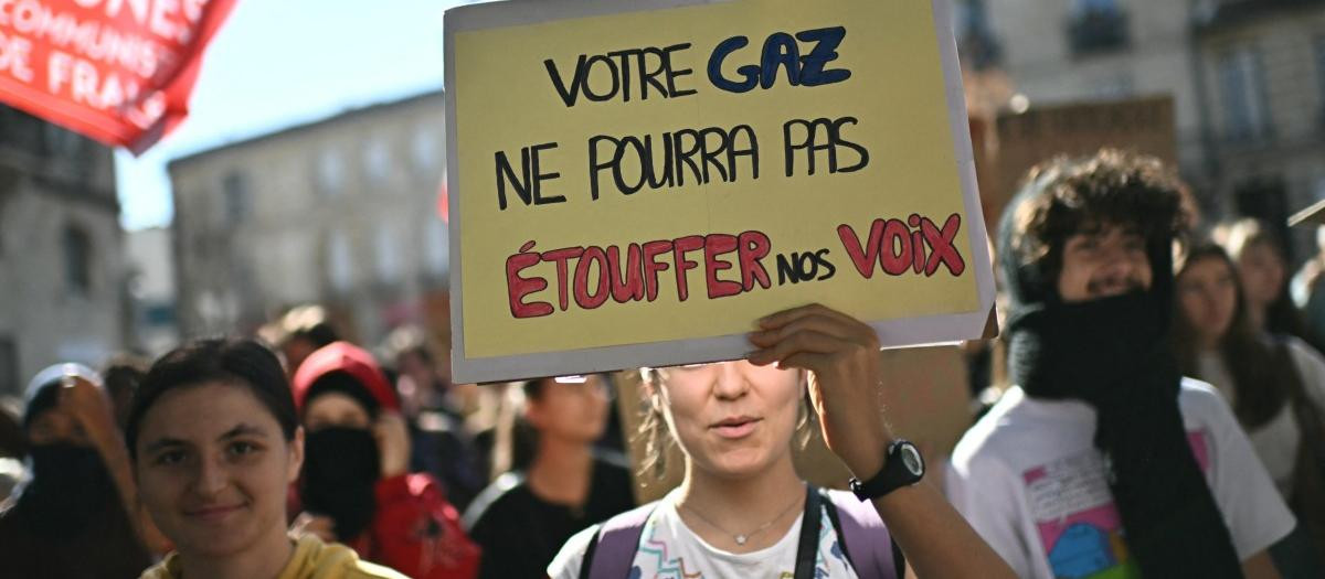 Protesters hold a placard reading "Were missing our lessons so we can teach you one" during a demonstration of high-school students in Bron, in the outskirts of Lyon, on October 8, 2026, as part of a nationwide protest movement over learning conditions. Since late September, pupils have barred the entrances to hundreds of schools, complaining of teacher absences, overloaded timetables, dilapidated classrooms and buildings ill-adapted to rising temperatures, among other grievances. (Photo by JEFF PACHOUD / AFP)