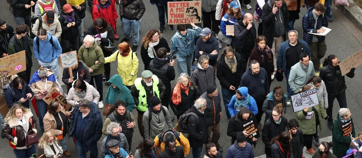 Protesters including one with a placard reading "better a pig than a fascist" referencing 
Japanese animator and filmmaker Hayao Miyazaki's film Porco Rosso take part in a demonstration "against racism, fascism and imperialism" on the sidelines of the Congress of the Far-right party Rassemblement National (RN) in Orleans, central France on October 24, 2026.. Amid another Saturday of protests under tight security across France, Orleans is hosting the National congress of the Far-right party Rassemblement National and preparing for a record-breaking demonstration, on the eve of their first major campaign rally. (Photo by SIMON WOHLFAHRT / AFP)