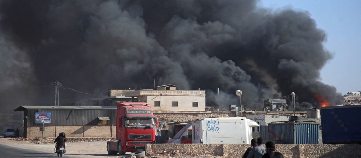 Smoke billows from a warehouse after reported shelling on the town of Sarmada in Syria's northwestern Idlib province on October 16, 2021. (Photo by Aaref WATAD / AFP)