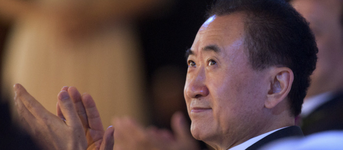 Wang Jianlin, chairman of Wanda Group applauds as he attends a signing ceremony for a strategic partnership between FIBA and Wanda Group in Beijing, Thursday, June 16, 2016.