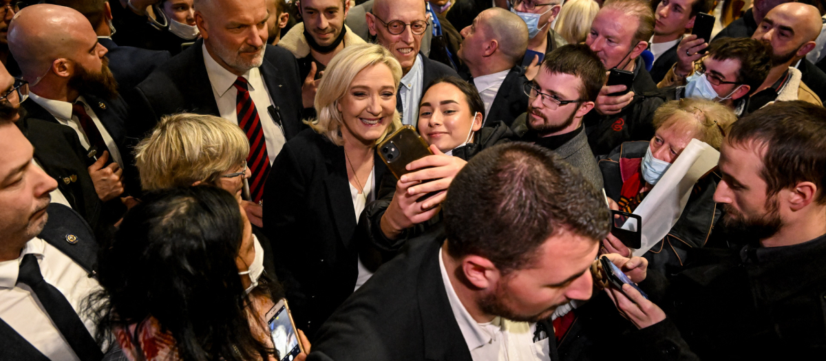 Far-right Rassemblement National (RN) party presidential candidate Marine Le Pen meets supporters during a campaign meeting in Vienne, southeastern France, on February 18, 2022.
