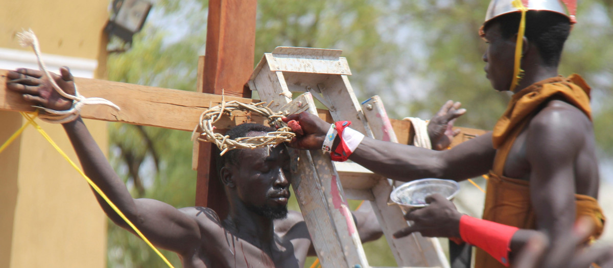 An unidentified South Sudanese dressed as Jesus Christ re-enacts the story of the crucifixion of Jesus Christ, during a procession to mark Good Friday in Juba, South Sudan, Friday, April 14, 2017