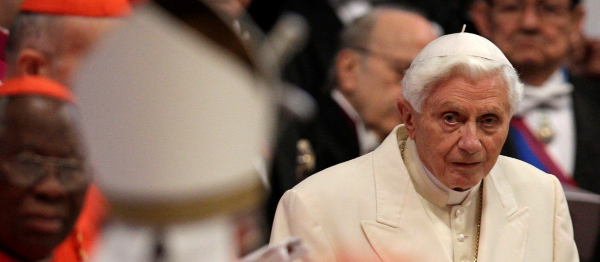 Pope Emeritus Benedict XVI looks at Pope Francis, left with back to camera, arriving as he attends a consistory inside the St. Peter's Basilica at the Vatican, Saturday, Feb.22, 2014.