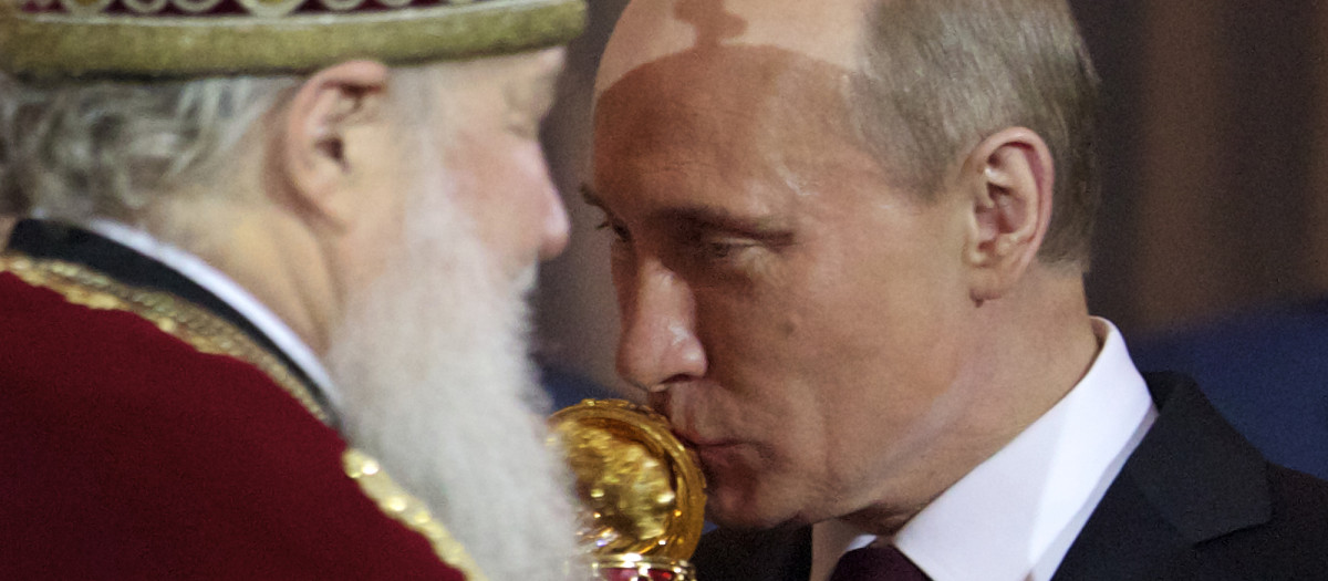 Russian Prime Minister and President-elect Vladimir Putin, right, kisses an Easter egg he was presented by Russian Orthodox Patriarch Kirill, left, during the Easter service in the Christ the Savior Cathedral in Moscow, Russia, Sunday, April 15, 2012