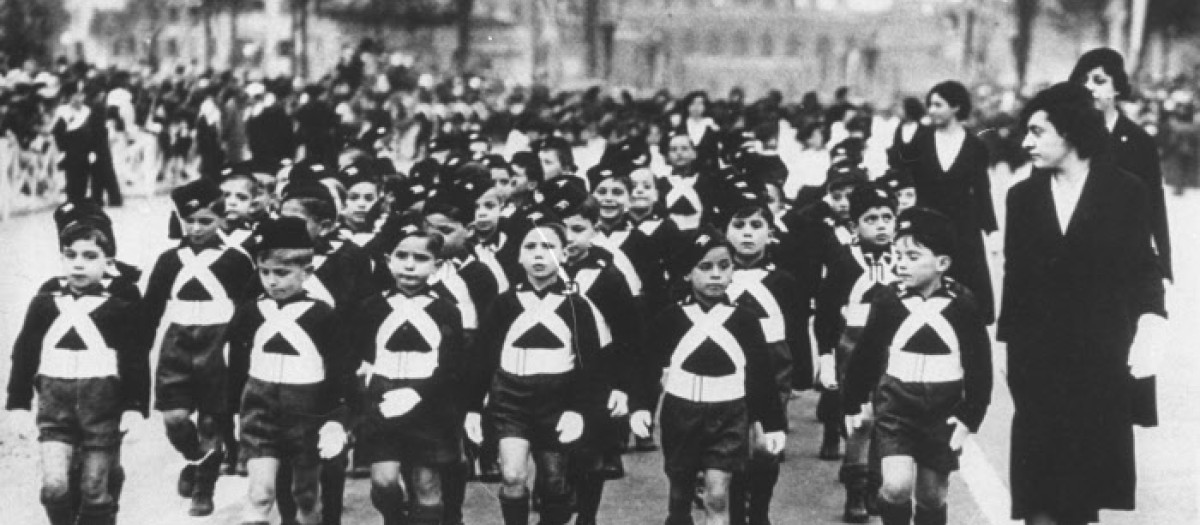 While it may be quite a spell before these youngsters see any real action, there's not doubt about their being real Italian "soldiers"  known by the ferocious names of "Sons of the Wolf."  They range in years from 6 to 8, and are seen in Rome, on June 8, 1935, when they passed in review before Mussolini, who has ordered military training for all males from 6 years to 33.  (AP Photo)