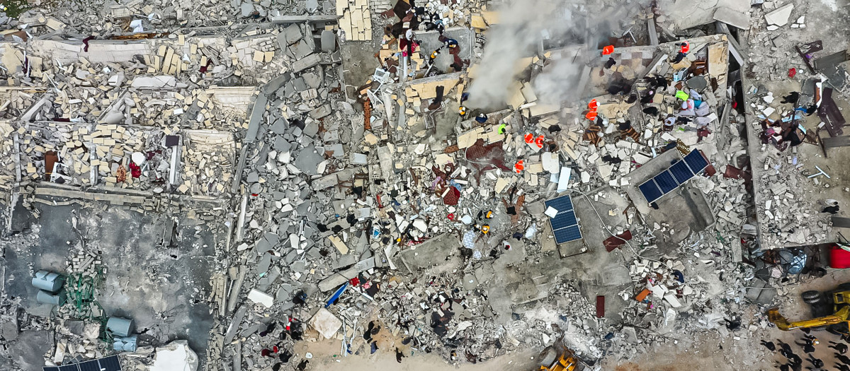 Rescue teams search for victims in the rubble following an earthquake in northwestern Syrian Idlib in the rebel-held part of Idlib province, on February 6, 2023. -