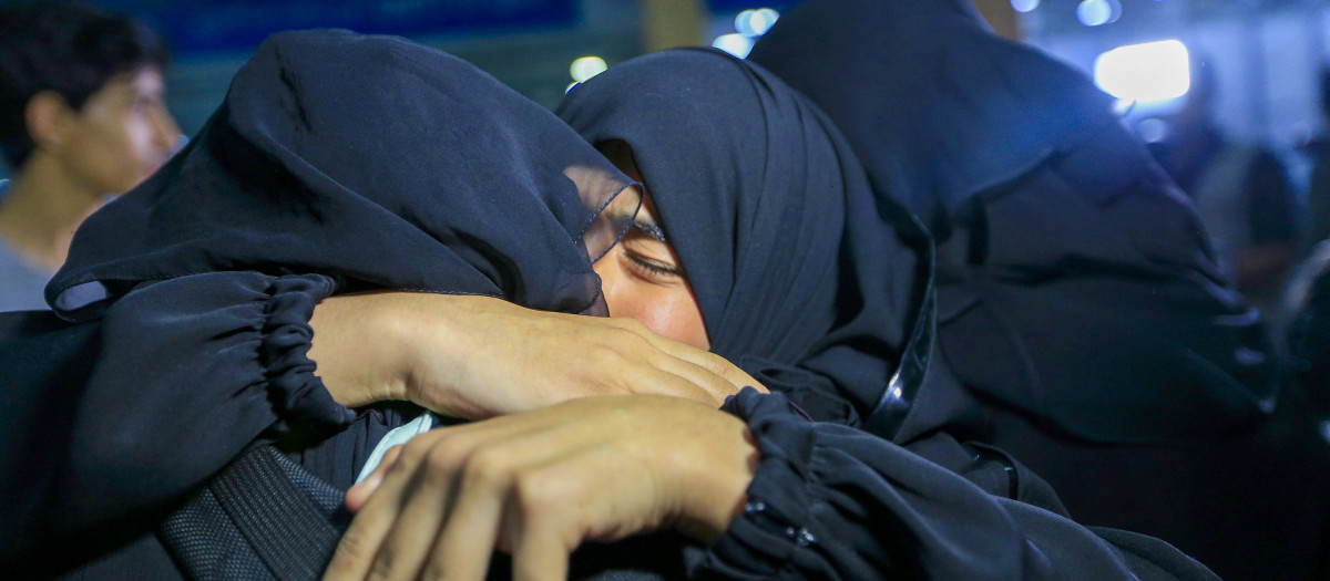 A woman embraces her relative upon arrival at the Sanaa International Airport in Sanna on May 14, 2023, after being evacuated from Sudan. Hundreds of people have been killed and nearly a million displaced in the war between the army and rival paramilitaries embroiled in a power struggle 18 months after a military coup derailed Sudan's transition to civilian rule. (Photo by Mohammed HUWAIS / AFP)