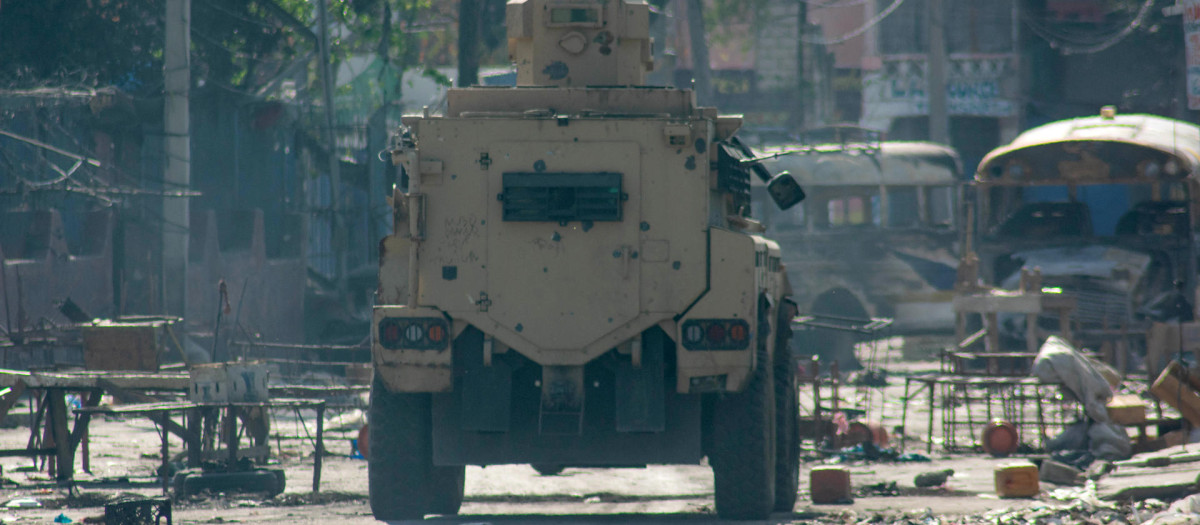 Un carro blindado circula durante los actos de saqueo en el centro de la ciudad, este sábado en Puerto Príncipe (Haití). Continúan los tiroteos esporádicos y los actos de saqueo este sábado en varios barrios el área metropolitana de Puerto Príncipe, creando una situación de miedo, incertidumbre y alerta constantes en la población. EFE/ Siffroy Clarens