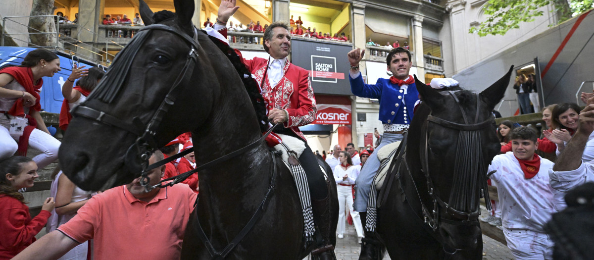 El rejoneador Pablo Hermoso de Mendoza (i), junto a su hijo Guillermo Hermoso de Mendoza (d), salen por la puerta grande de la Plaza de Toros de Pamplona en la segunda de abono de los Sanfermines 2024