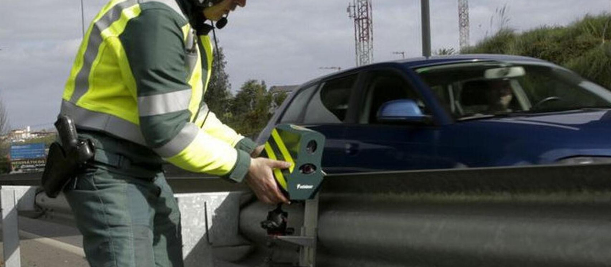 Un agente de la Guardia Civil coloca uno de los nuevos radares Velolaser