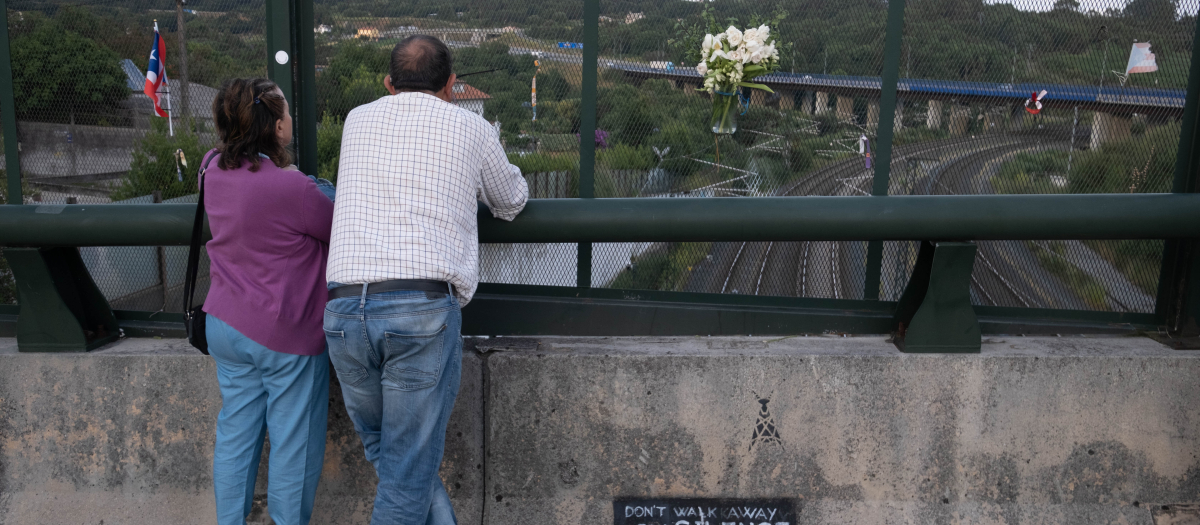 Varias personas en el lugar del descarrilamiento del Alvia durante un homenaje en el barrio de Angrois, Santiago de Compostela