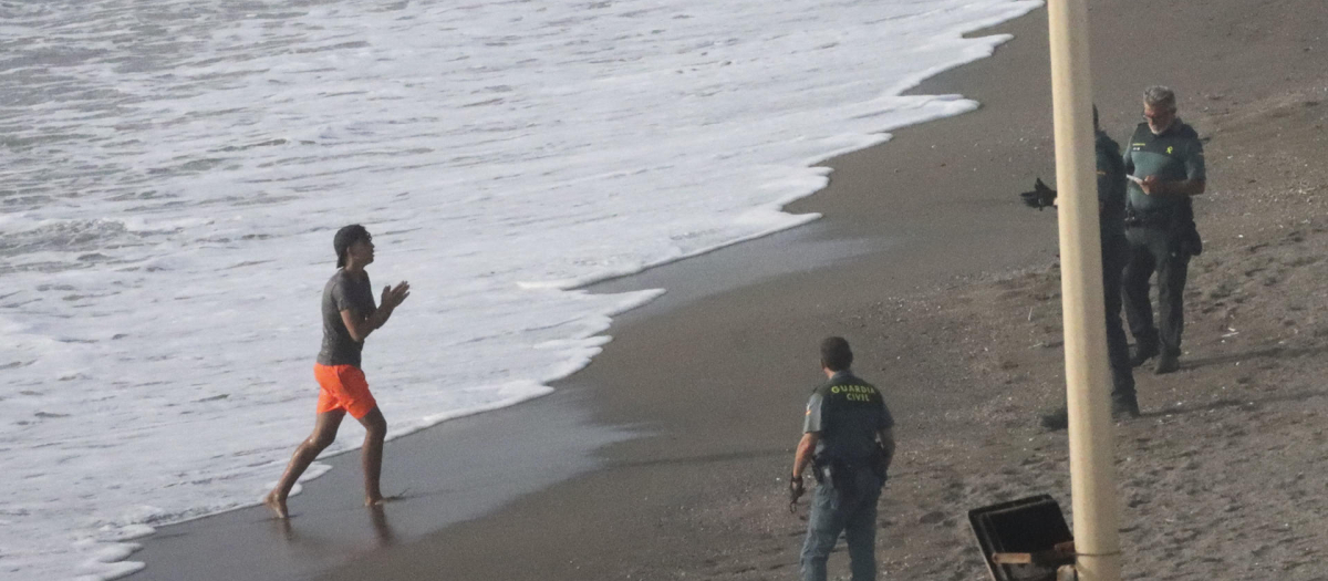 Guardias civiles esperan la llegada de un nuevo inmigrante en la playa del Tarajal