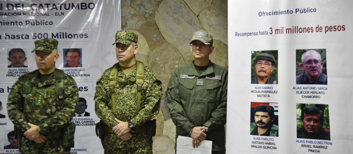 Colombian soldiers stand next to a banner with the most wanted members of the National Liberation Army (ELN) guerrilla group during a press conference by the Colombian Defense Minister Ivan Velazquez after his visit to the Catatumbo region in Cucuta, Norte de Santander Department, Colombia on January 24, 2025. The Colombian government launched a military offensive against ELN guerrillas on the border with Venezuela, who for the past week have been waging a bloody attack that has left more than 80 dead and 38,600 displaced. (Photo by Schneyder Mendoza / AFP)