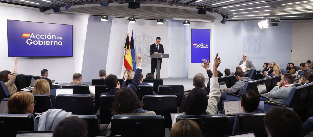 Los periodistas levantando el brazo durante la comparecencia de Sánchez