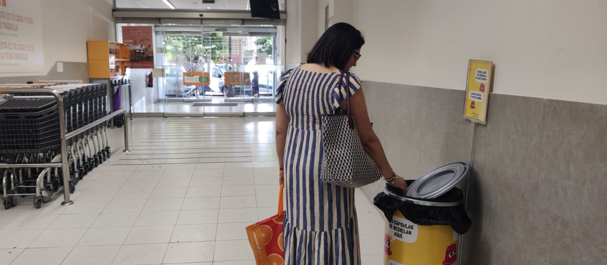Imagen de archivo de una persona utilizando los nuevos contenedores de reciclaje de Consum