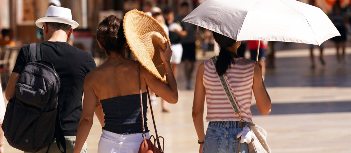 Imágenes de personas  por las calles de Málaga en plena ola de calor