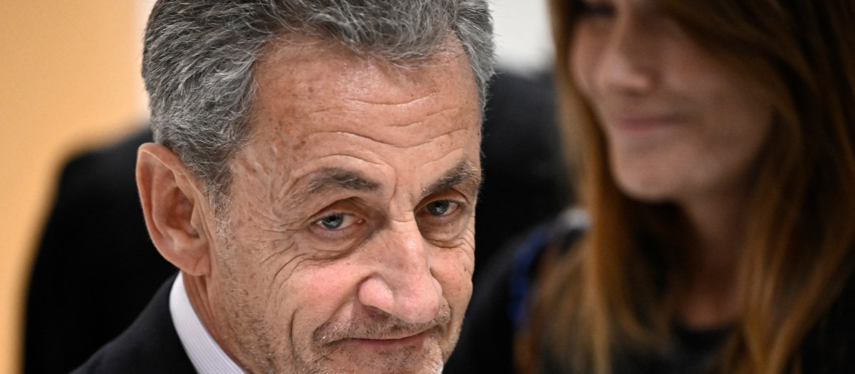 Former French president Nicolas Sarkozy leaves next to his wife French-Italian singer Carla Bruni after the verdict in his trial for illegal campaign financing from Libya for his successful 2007 presidential bid, at the Tribunal de Paris courthouse in Paris, on September 25, 2025. A Paris court on September 25, 2025 sentenced former French president Nicolas Sarkozy to five years and ordered him to go to prison after finding him guilty of criminal conspiracy over accusations the late Libyan dictator Moamer Kadhafi helped fund his victorious 2007 presidential run. The court ordered that Sarkozy should be placed in custody at a later date, with prosecutors given one month to inform the former head of state when he should go to prison. (Photo by JULIEN DE ROSA / AFP)