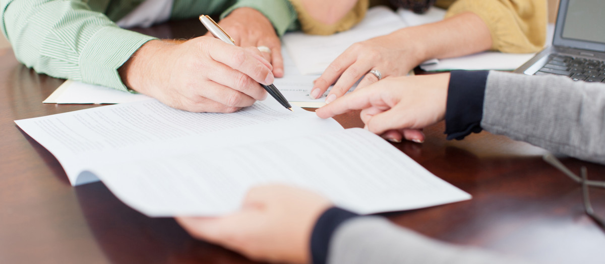 Pareja firmando un préstamo hipotecario