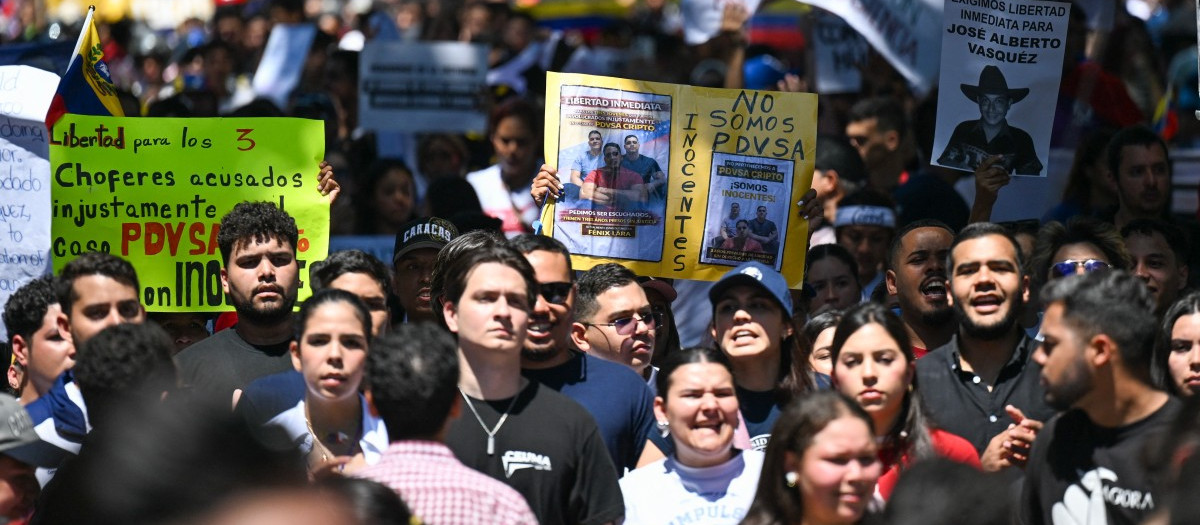 University students, opponents of the government, and relatives of political prisoners, take part in a march on the Youth Day in Caracas on February 12, 2026. The first major opposition demonstration after the fall of Nicolas Maduro during a US military incursion a month ago gathered thousands of people in Venezuelas capital on February 12, ahead of the approval of a historic amnesty law. (Photo by Juan BARRETO / AFP)