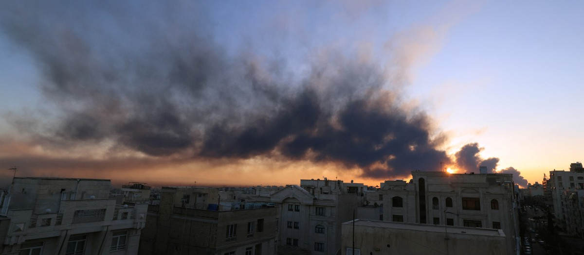 The sun is seen through a plume of black smoke following a strike on the Iranian capital Tehran, on March 3, 2026. Iran stepped up its attacks on economic targets and US missions across the Middle East on Tuesday as the US president warned it was "too late" for the Islamic republic to seek talks to escape the war.  The United States and Israel launched strikes against Iran on February 28, with the killing of Iran's supreme leader and the Islamic republic retaliated with barrages of missiles at Gulf states and Israel. (Photo by ATTA KENARE / AFP)