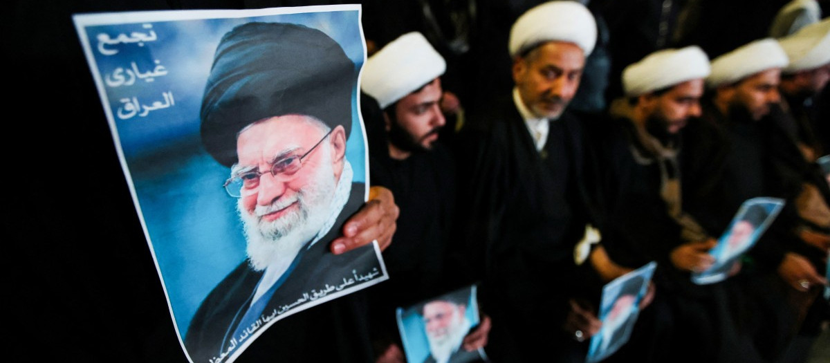 Shiite Muslim clerics hold posters of the late Iranian supreme leader Ayatollah Ali Khamenei, assassinated in a US-Israeli attack on Tehran, as they rally in Tahrir Square, in the Baghdad on March 6, 2026. The United States and Israel launched strikes against Iran on February 28, killing Iran's supreme leader and top military leaders, prompting authorities to retaliate with strikes on Israel and across the Gulf. Fresh strikes rocked Iran and Lebanon on March 6, as Israel and the United States stepped up their attacks in the sprawling Middle East war, with powerful explosions shattering the skies of Tehran. (Photo by Murtaja LATEEF / AFP)