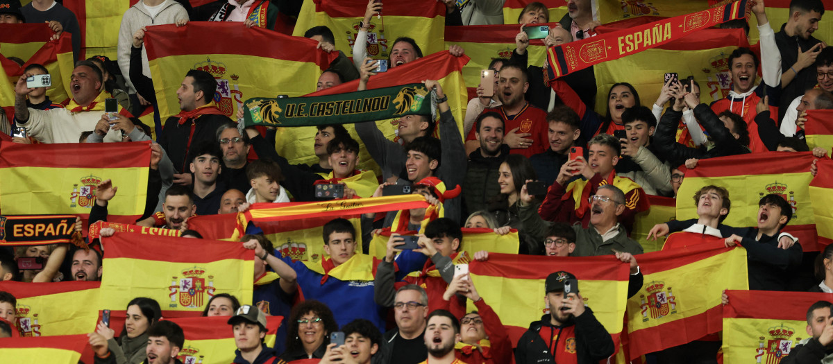 Los aficionados despliegan la bandera de España en el momento del himno nacional