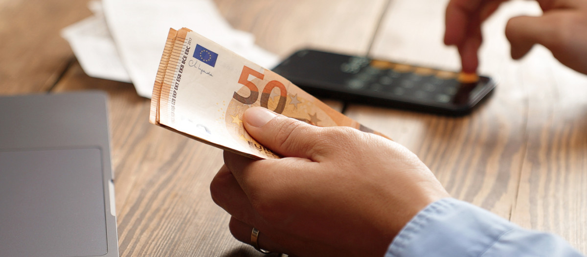 Una persona contando billetes de 50 euros