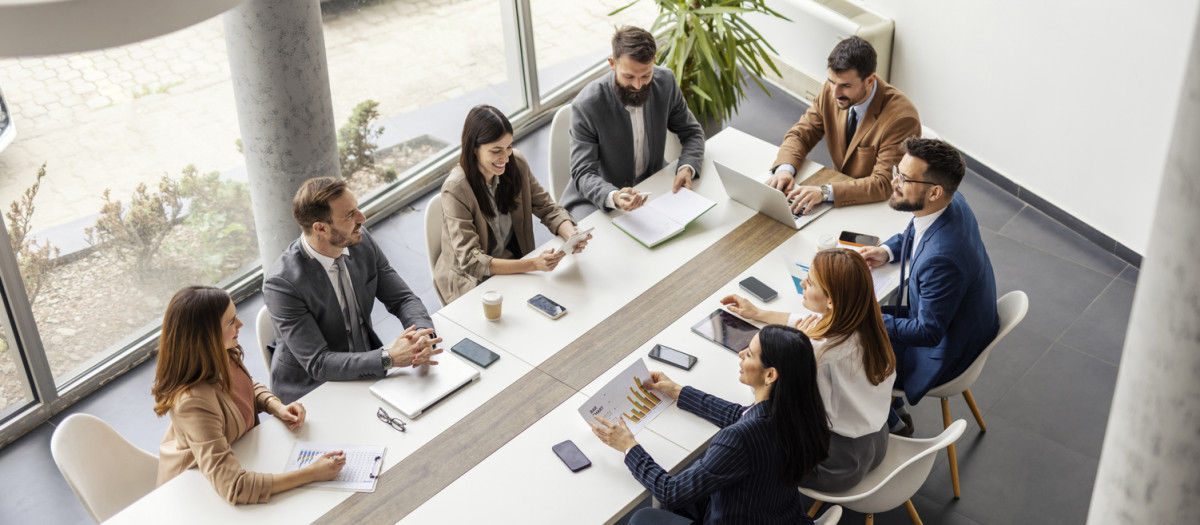 Top view of team collaborating and working on case study at boardroom.